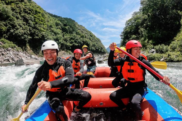 group of guys white water rafting